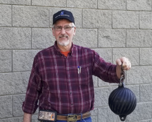 Tom Watkins Holding a Wayne Sewer Ball